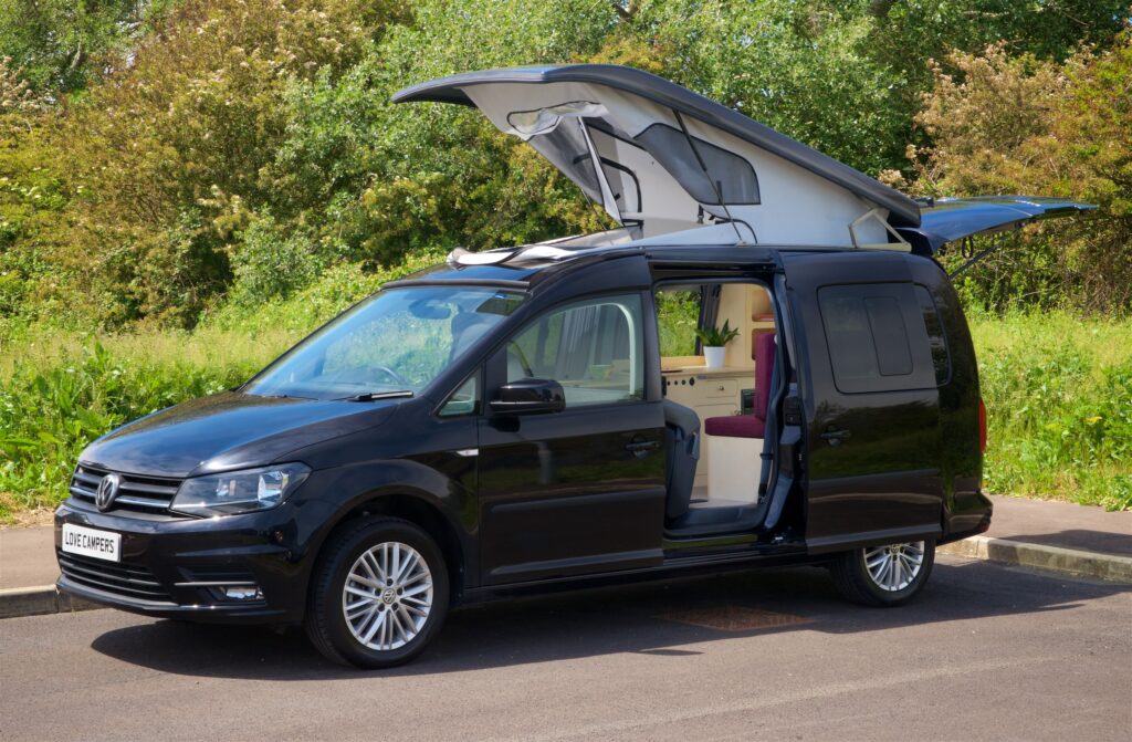 The exterior of a VW Caddy with pop-top roof